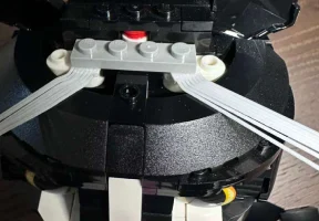 Attach under or on top of grey piece